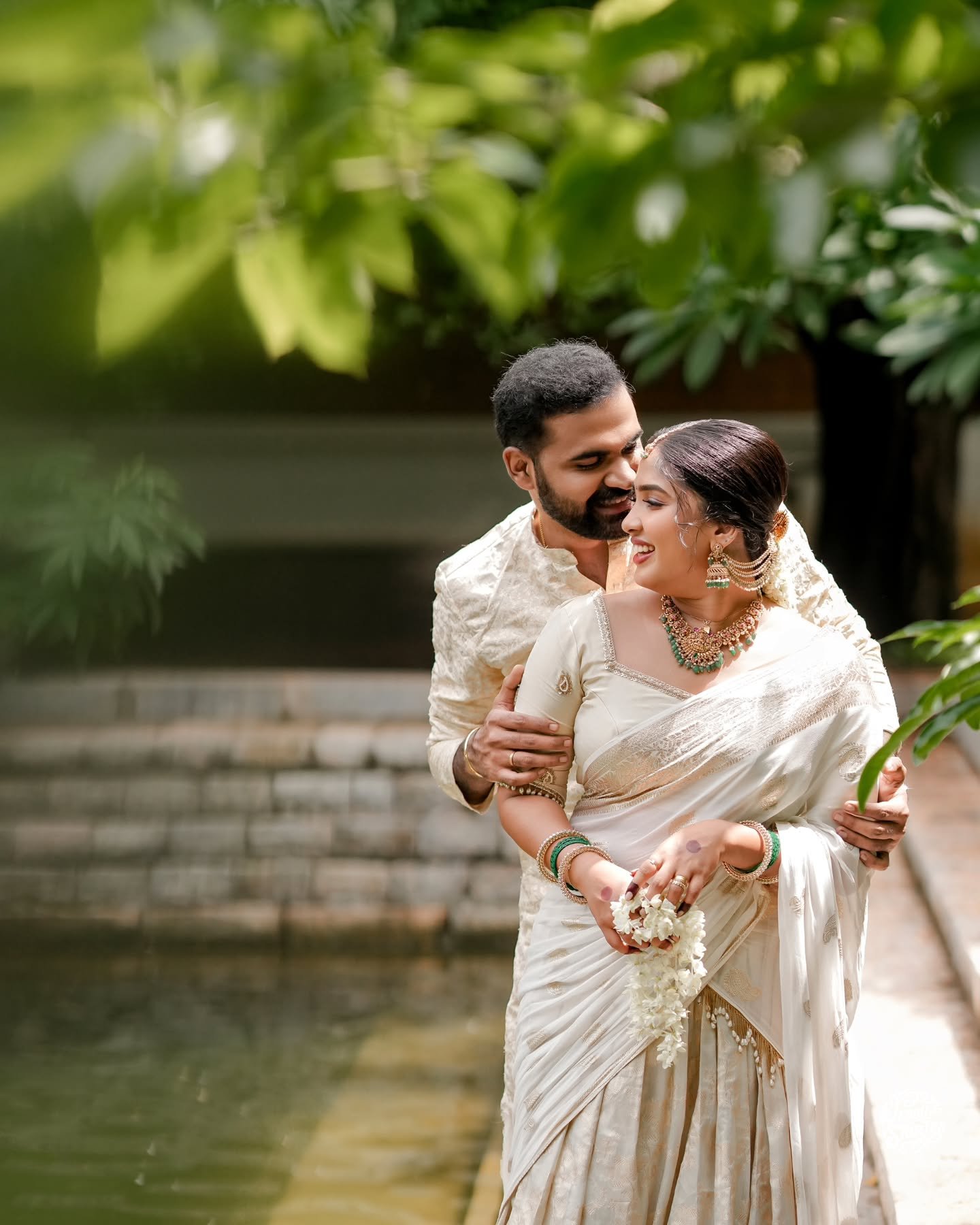 A newlywed couple embracing during their traditional ceremony